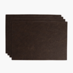 Stack of dark brown leather card sleeves on a light background