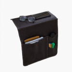 Black leather wall pocket organizer holding glasses, mail, and small accessories on a light background.