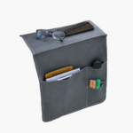 Gray leather wall pocket organizer holding glasses, mail, and small accessories on a light background.