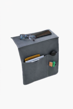 Gray leather wall pocket organizer holding glasses, mail, and small accessories on a light background.