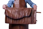 Leather knife holder professional 11s unrolled showing the protective flap cover and side zipper pocket, held open by chef