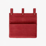 Red leather wall pocket organizer with three hanging tabs on a light background.