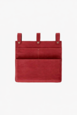 Red leather wall pocket organizer with three hanging tabs on a light background.