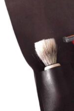 leather shaving case open showing 3 slots for razor brush