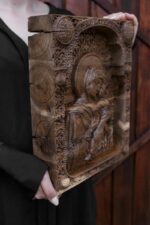 Virgin Mary holding in her arms the baby Jesus – carved icon close-up