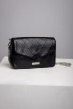 Black quilted leather envelope bag with silver chain at an angle
