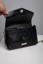 Black quilted leather chain bag opened showing zip pocket and snap closure