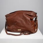 Brown leather slouch shoulder bag front view with adjustable strap