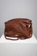 Brown leather slouch shoulder bag front view with adjustable strap