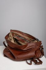 Interior of the brown leather shoulder bag with patterned lining and zip pocket