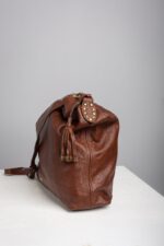 Profile of the brown leather hobo bag with studded leather tassel charm