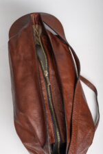 Top zip closure of the brown leather shoulder bag opened