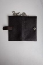 Dark brown leather wallet on chain opened flat showing snap tab