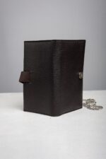Side view of the dark brown leather wallet clutch with removable chain