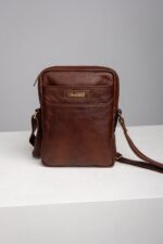 Mens brown leather reporter crossbody bag front view with front pocket