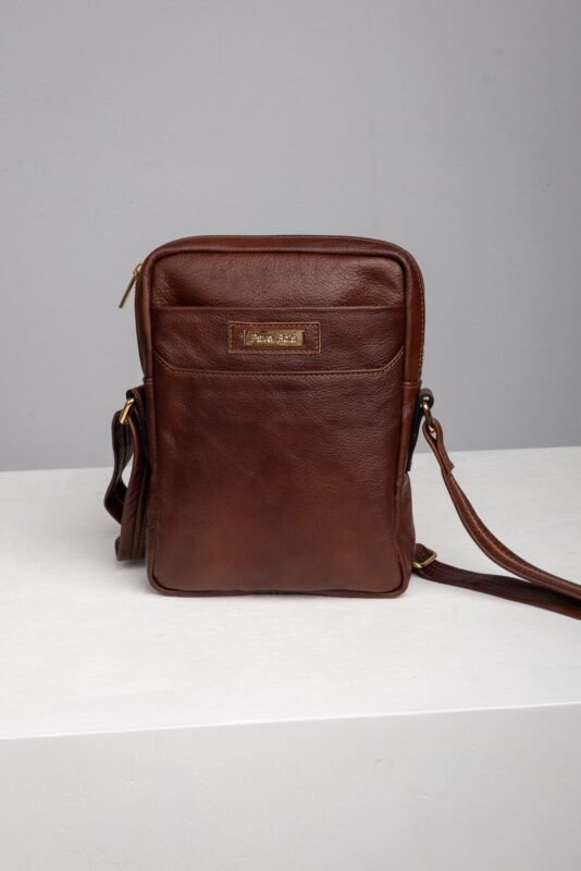 Mens brown leather reporter crossbody bag front view with front pocket