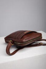 Adjustable leather shoulder strap detail on the mens reporter bag