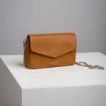 Tan leather chain crossbody bag with envelope flap front view
