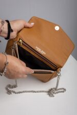 Interior of the tan leather chain crossbody bag with zip pocket