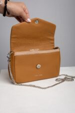 Tan leather chain bag opened showing envelope flap and snap closure