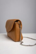 Side view of the tan leather chain shoulder bag with silver chain strap