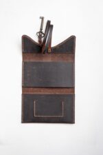 Vintage brown leather tobacco pouch open with inner pockets
