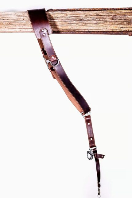 Angled view of the Garioch single camera strap in dark brown leather showing length and hardware connection.