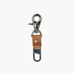 Leather Tow Anchor Vintage attached to a camera strap for keeping the camera close to the body, lifestyle close-up